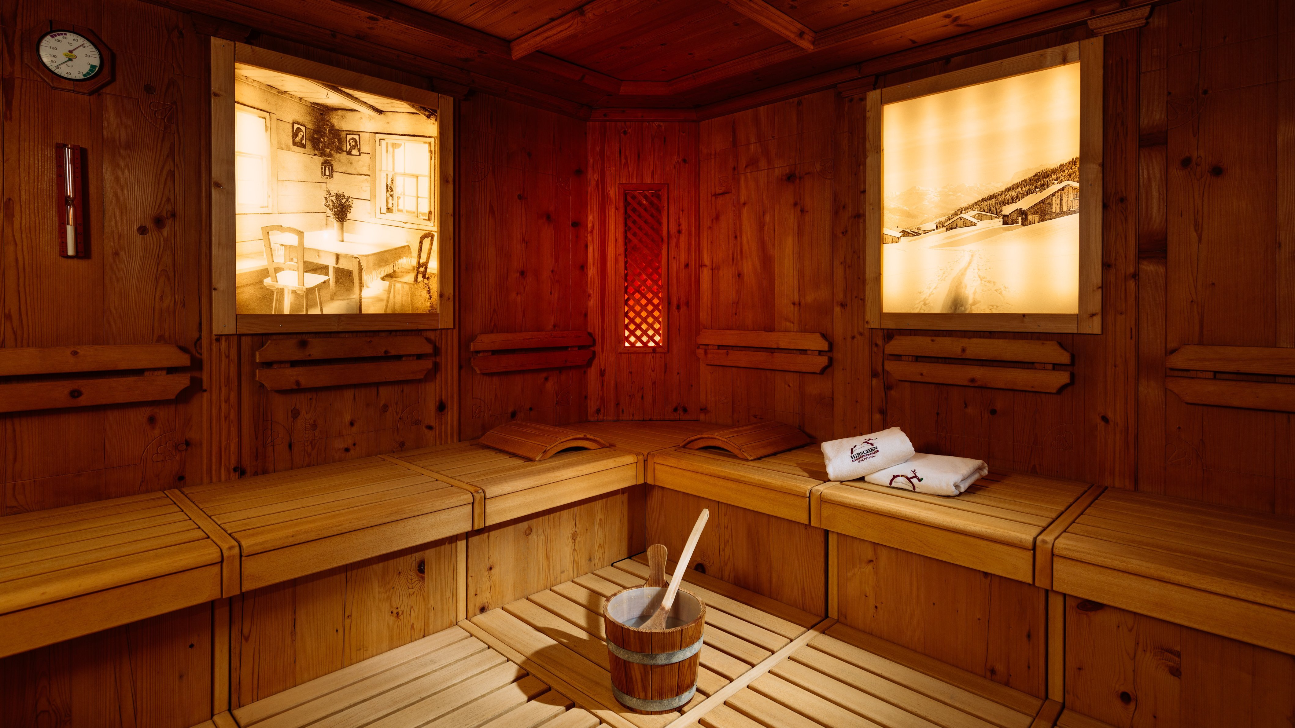 Relax in the Tranquil Sauna Interior view of a wooden sauna with benches and illuminated wall panels for relaxation