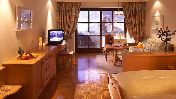 Cozy Hotel Room for Relaxation Comfortable hotel room with a living area, sofa, and large windows providing natural light