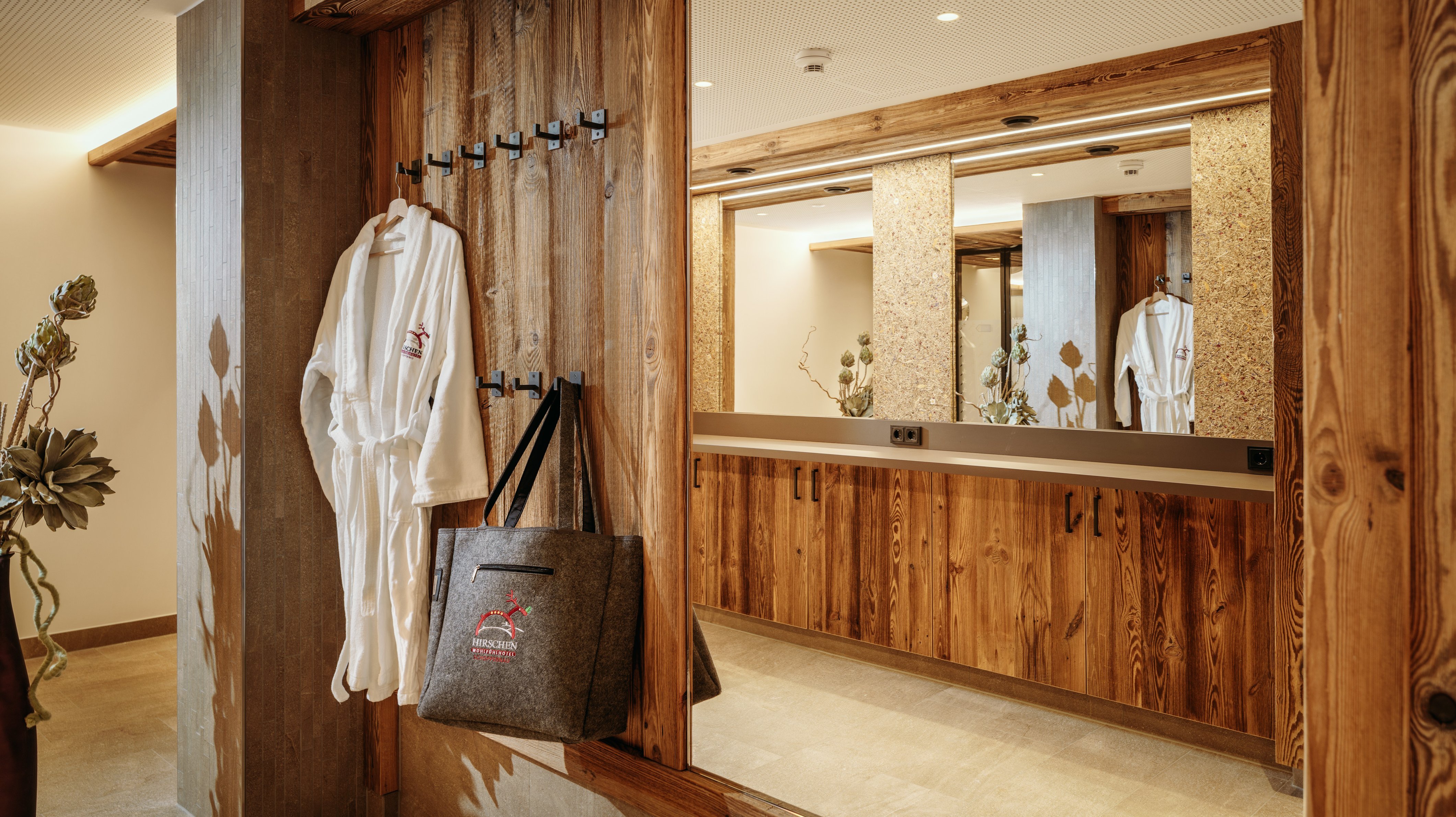 Luxury Bathroom Retreat at Hirschen Wohlfühlhotel Stylish hotel bathroom featuring wooden decor and relaxing spa amenities for guests